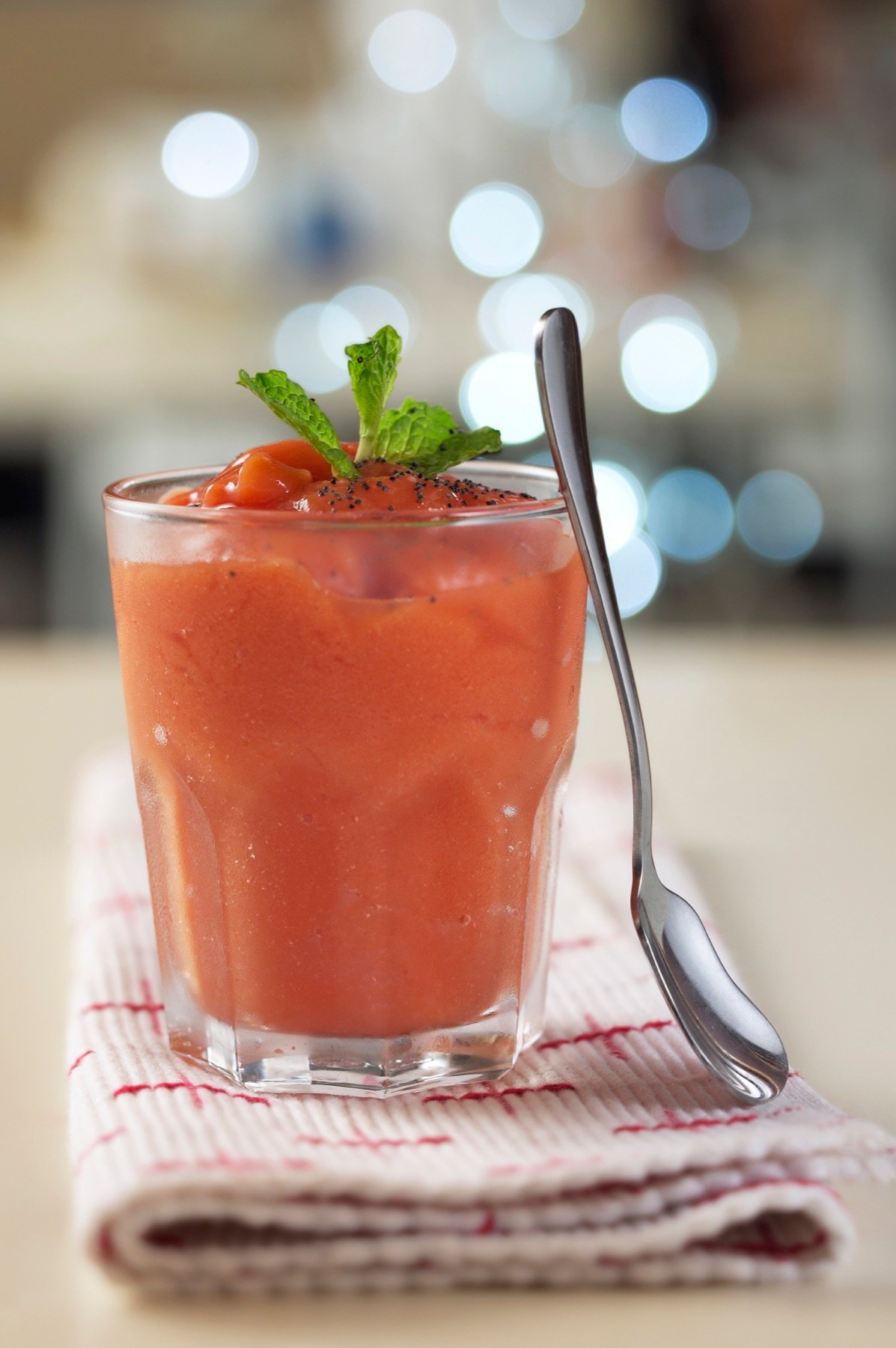 A chilled red drink with fresh garnish