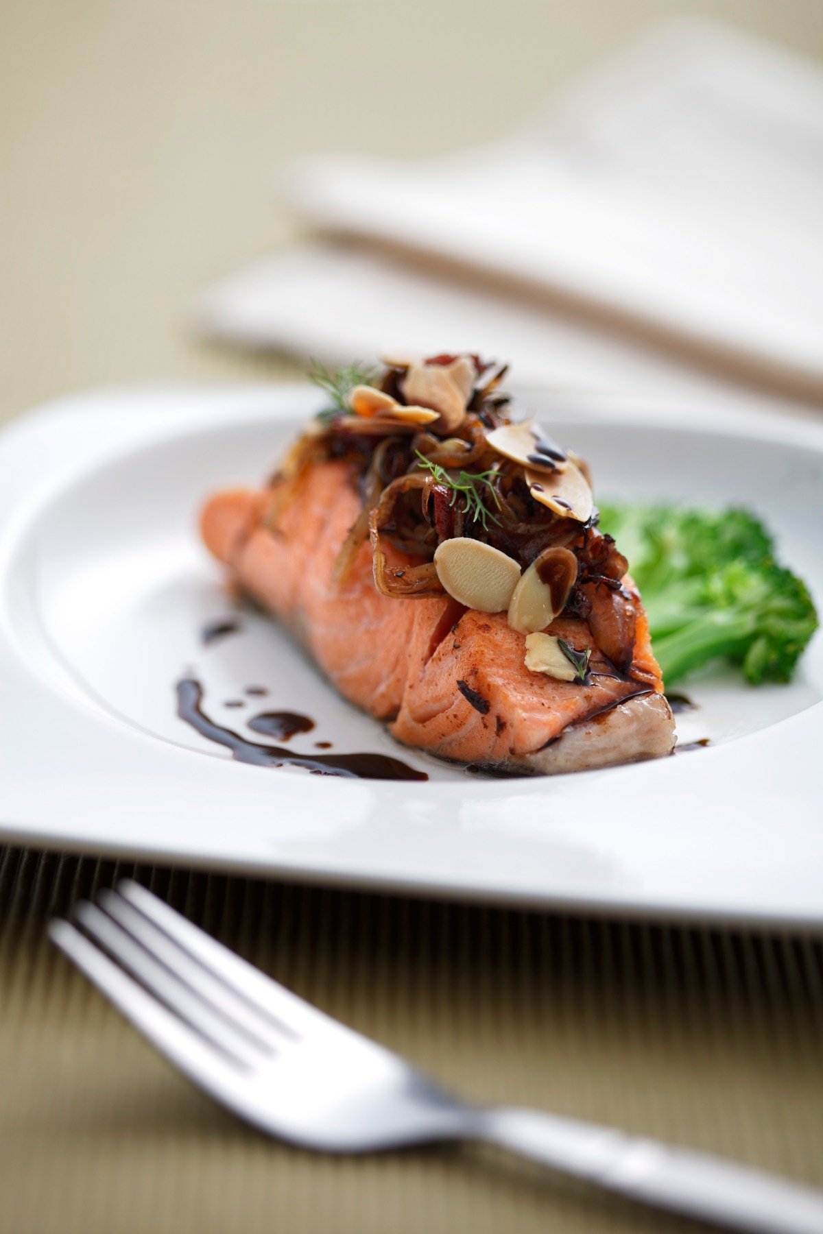 Seared fish with greens on a white plate