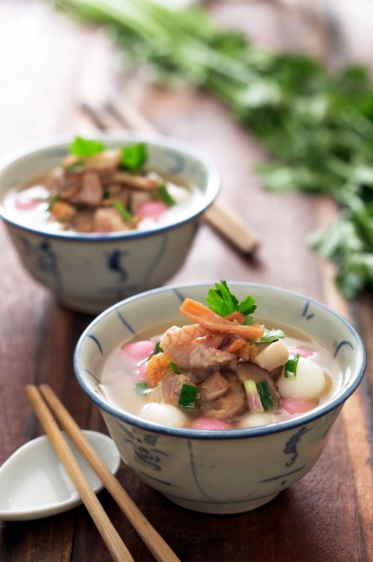 A bowl of soup topped with fresh herbs