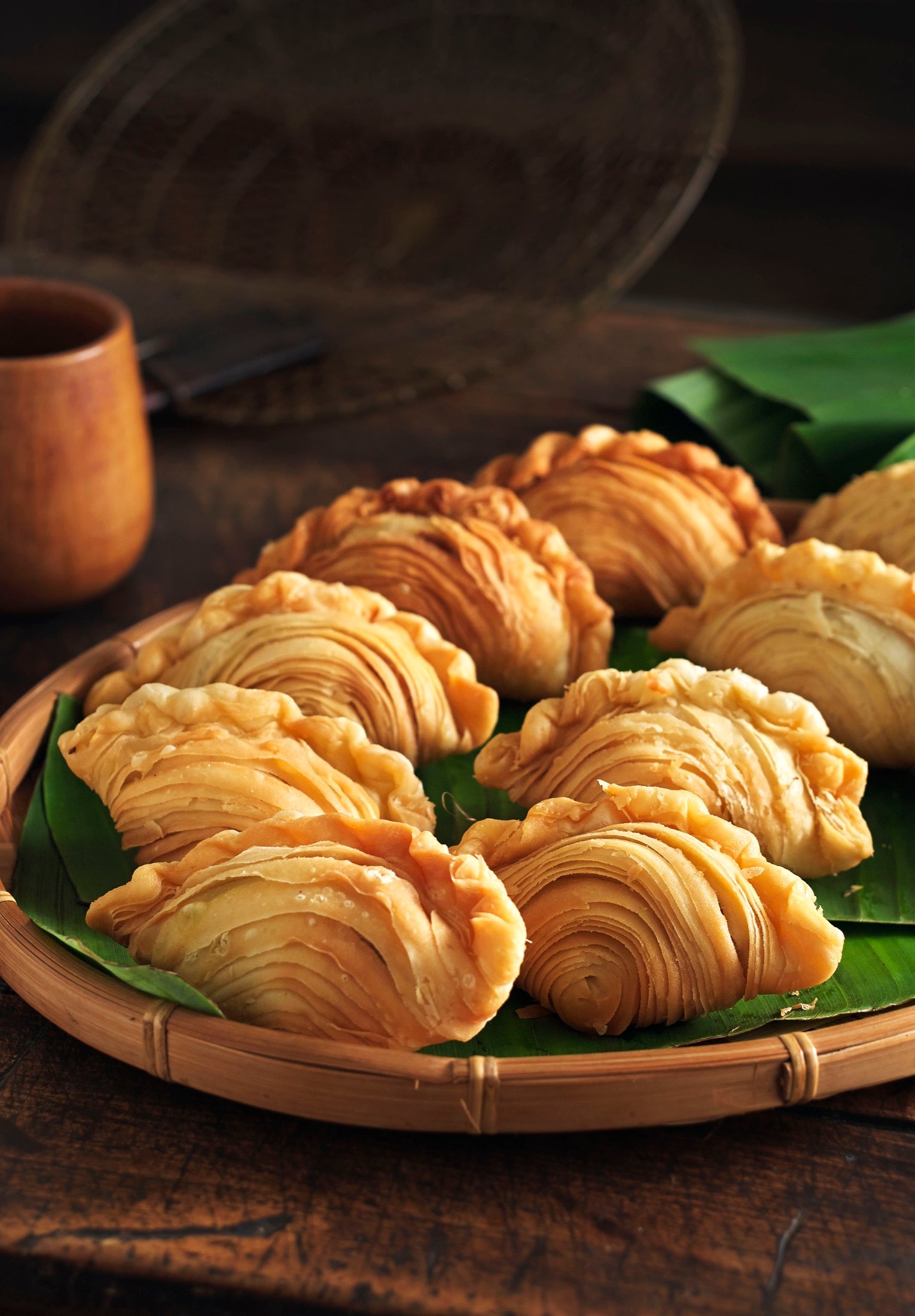 Golden pastries served on a dark table