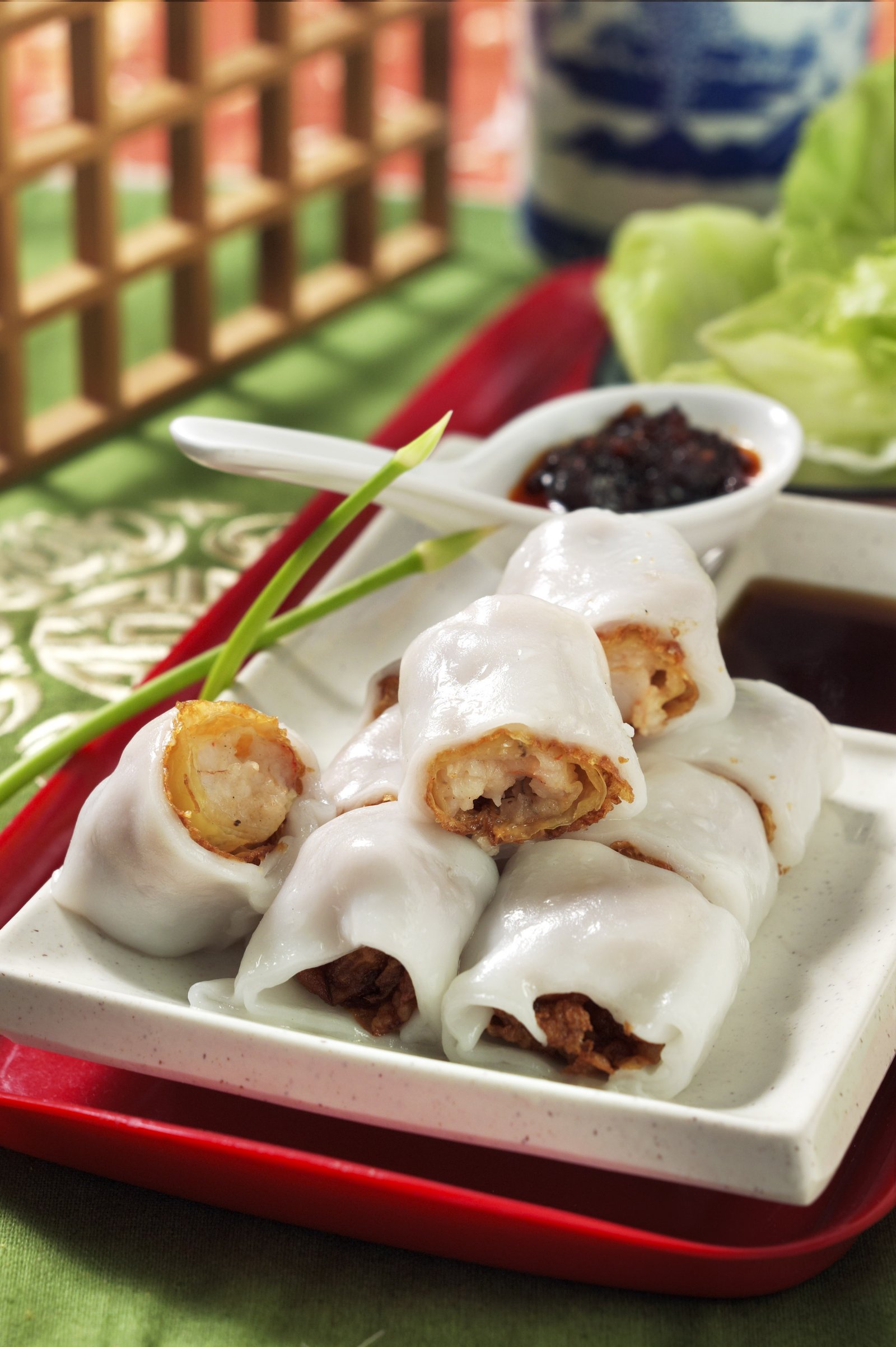 Rice noodle rolls served on a white plate