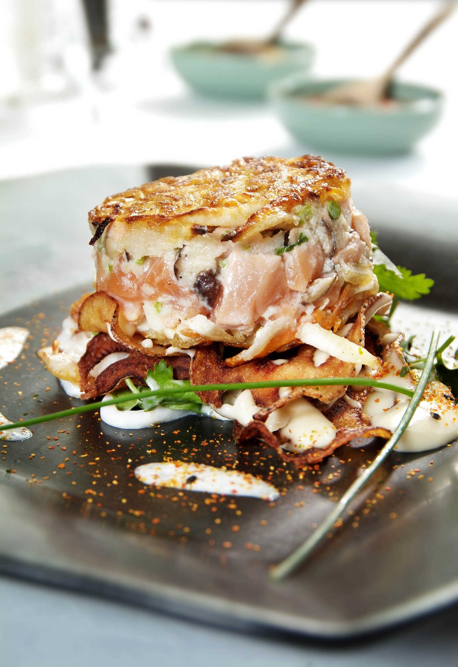 A layered savoury dish plated with fresh herbs