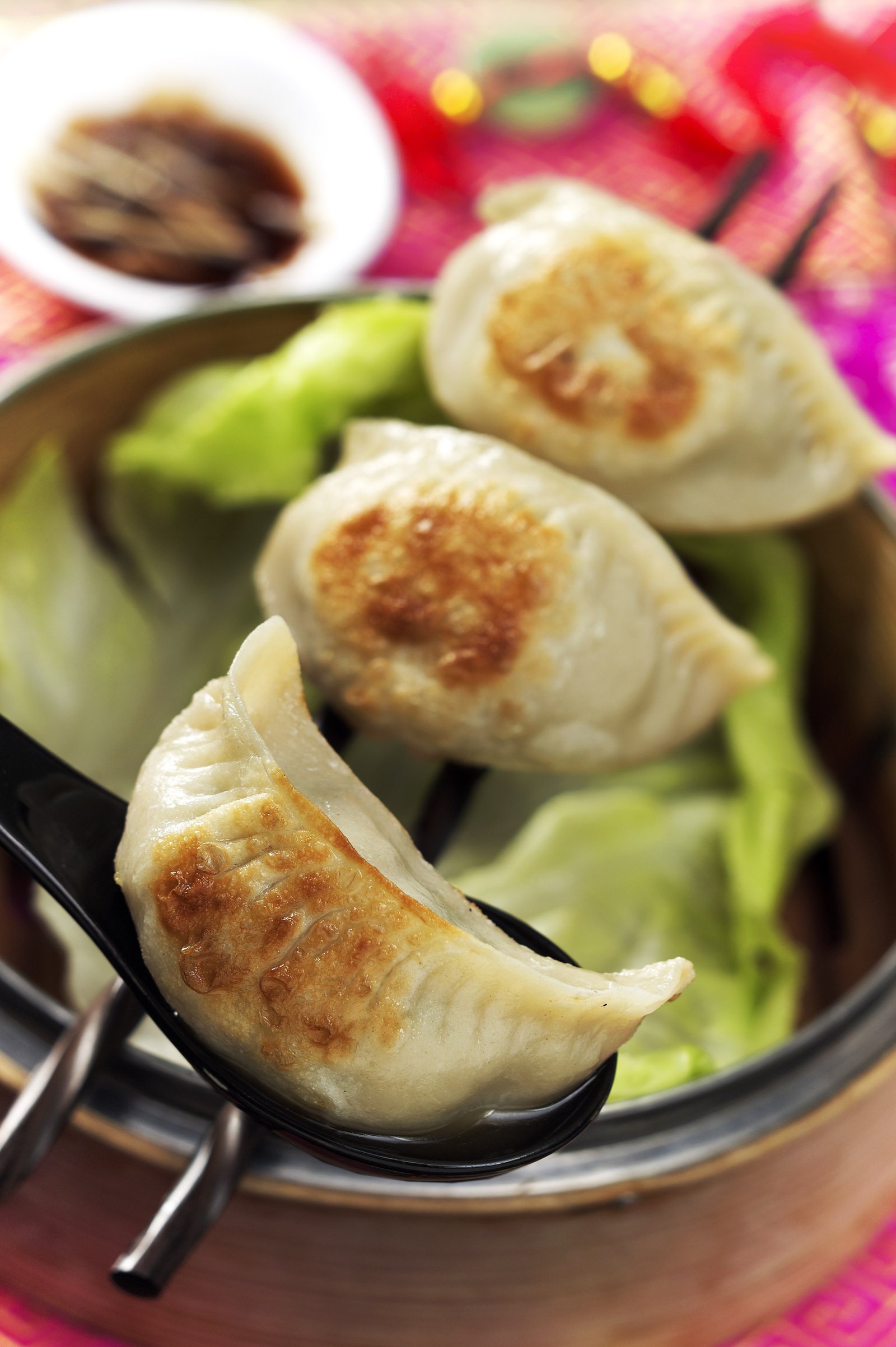 Pan-fried dumplings arranged in a steamer