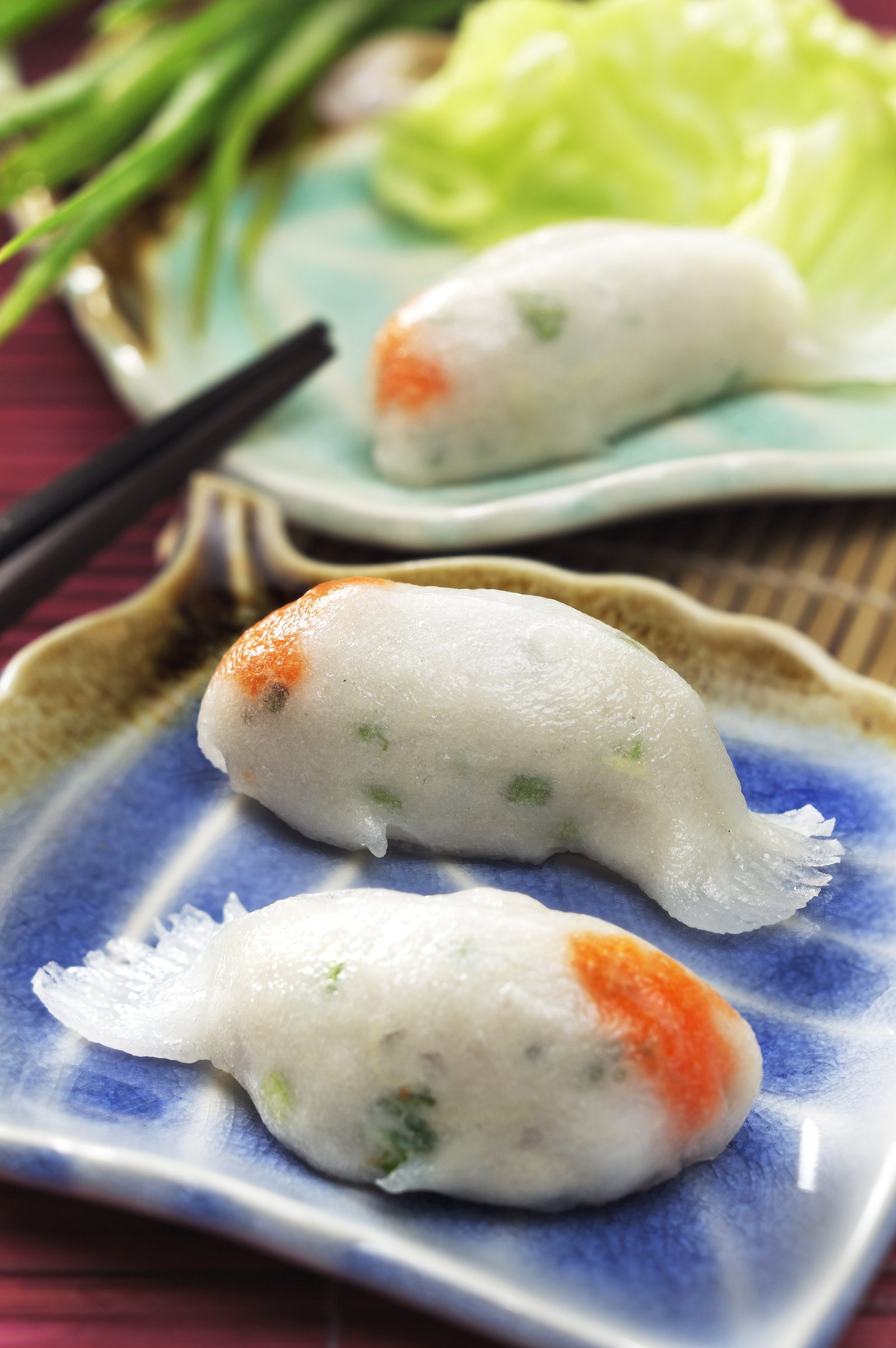 Steamed rice rolls served on blue plates