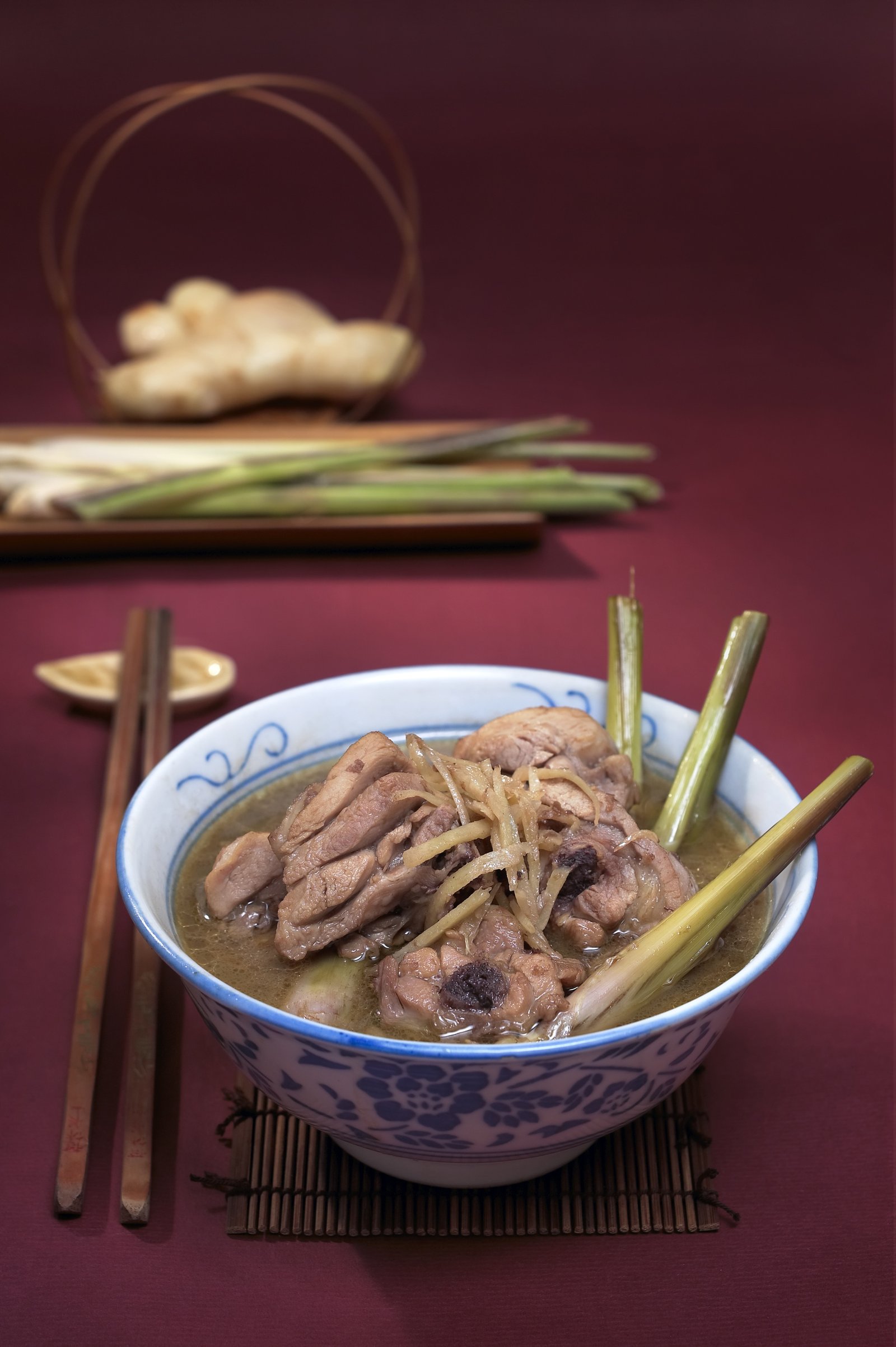 A bowl of noodles with meat and fresh herbs