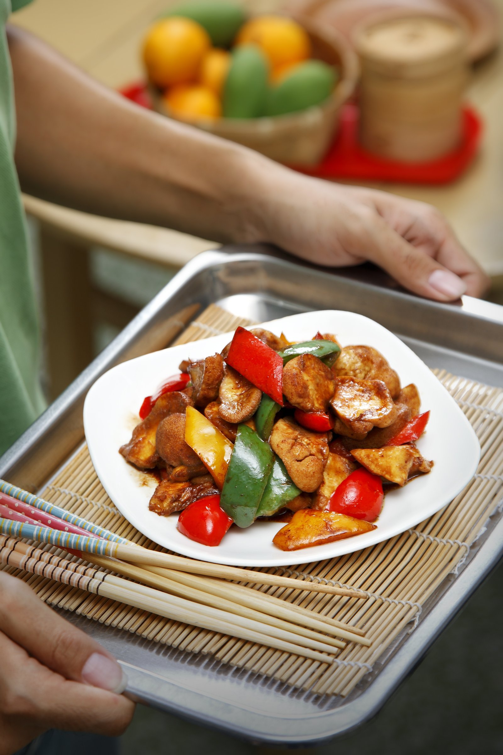 A plated stir-fry being served at the table