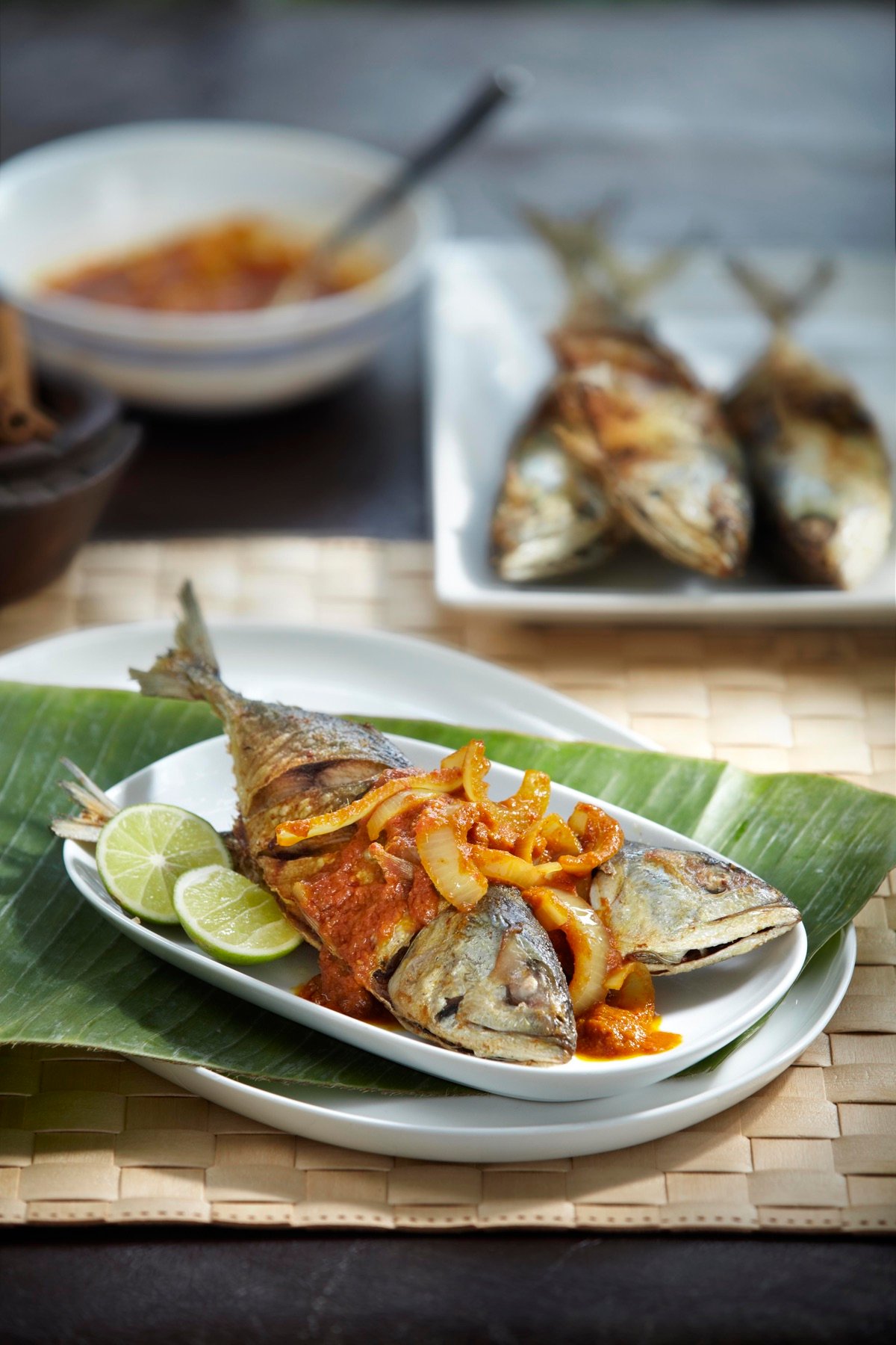 Grilled fish plated with fresh greens