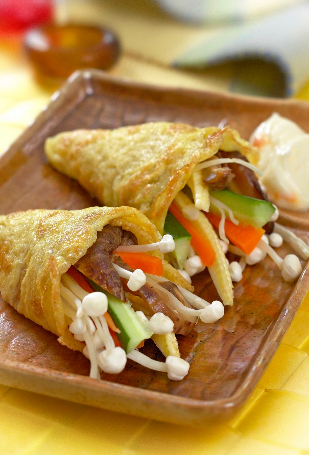 Crisp spring rolls served on a wooden board