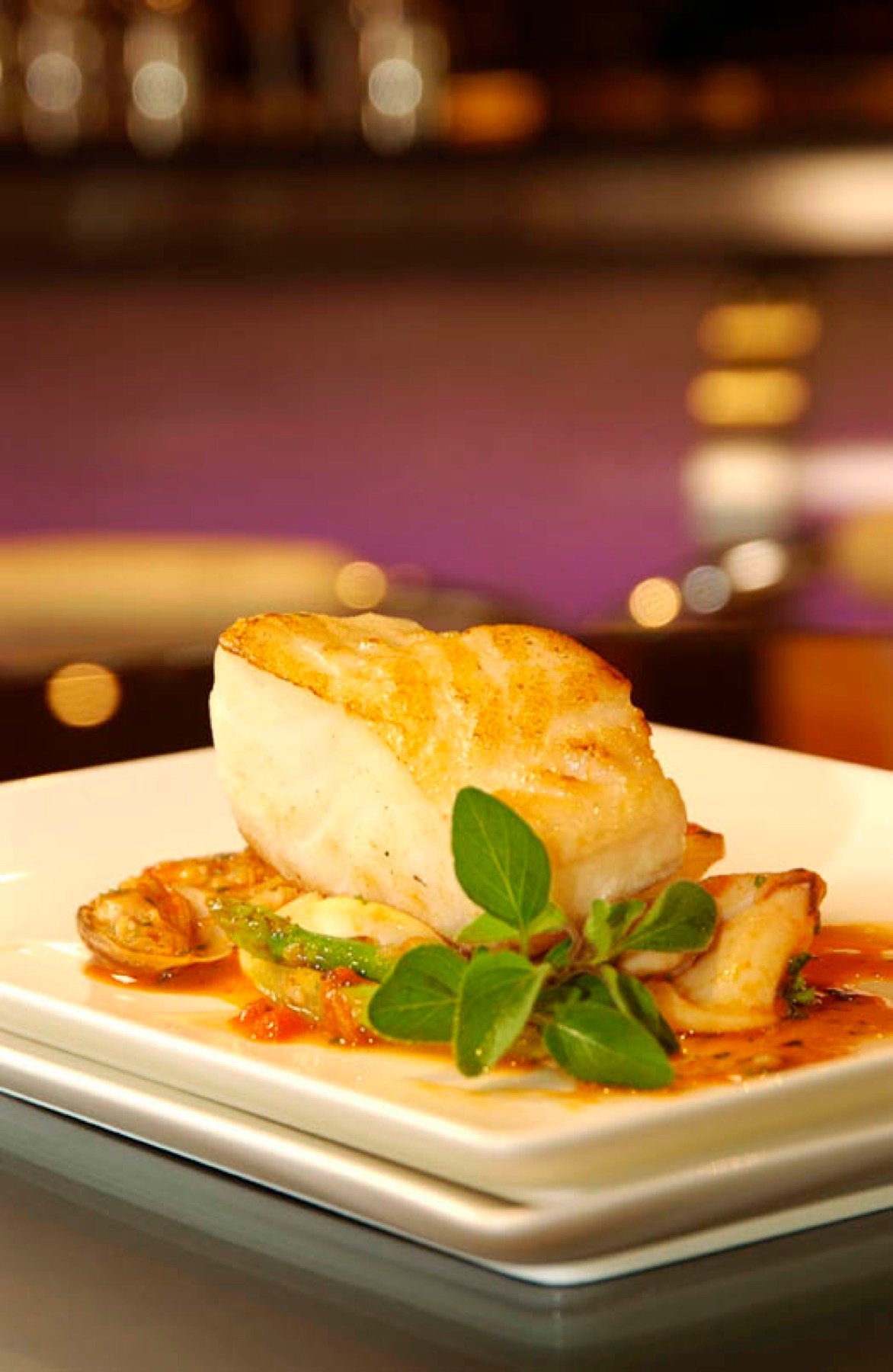 A plated fish dish with seasonal vegetables