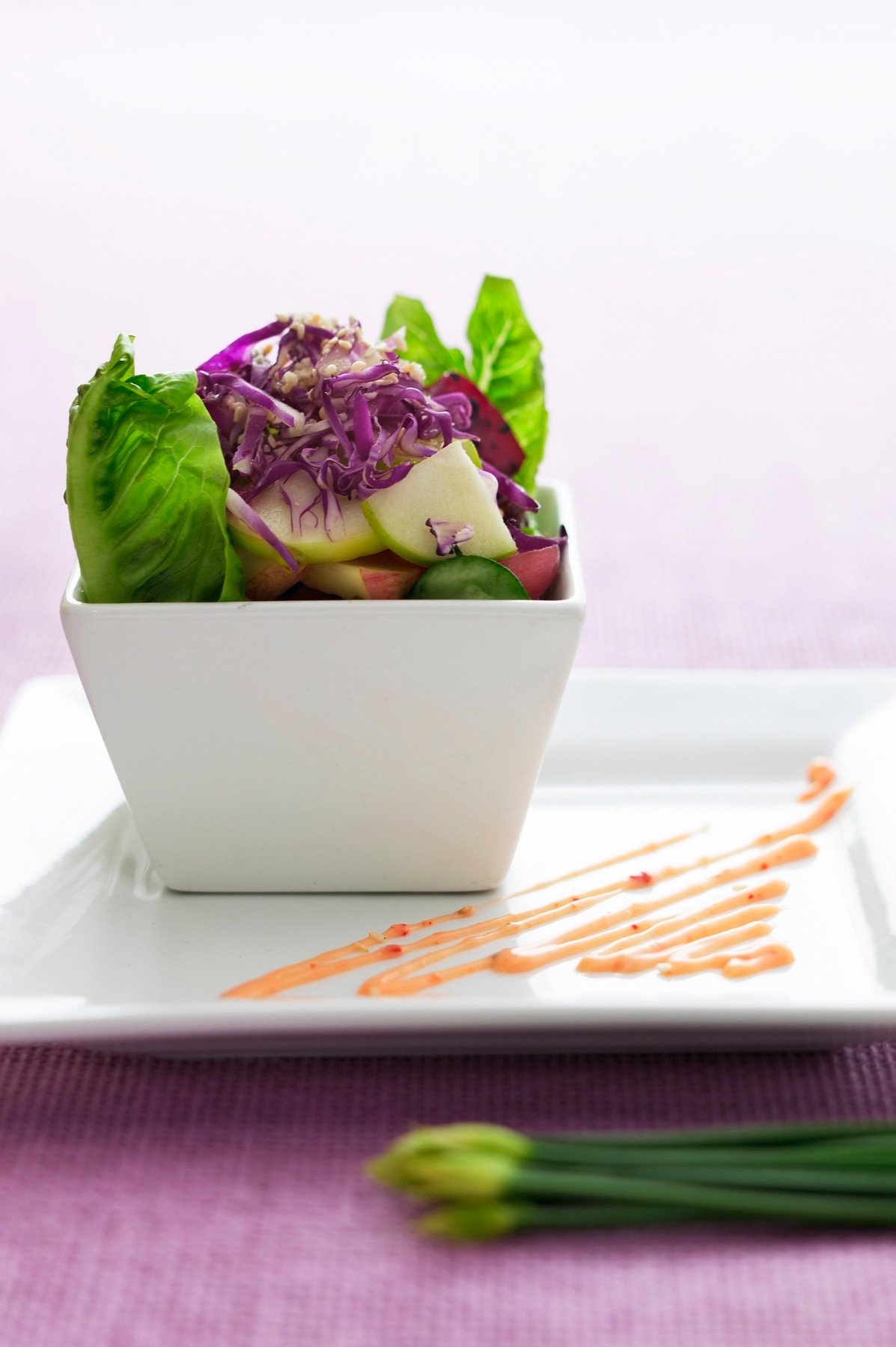 A fresh salad arranged in a white bowl