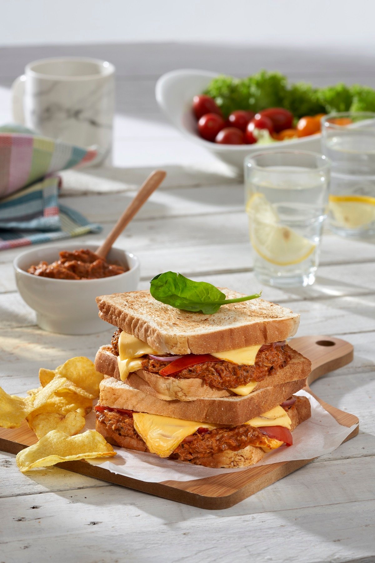 A toasted sandwich served with a fresh salad