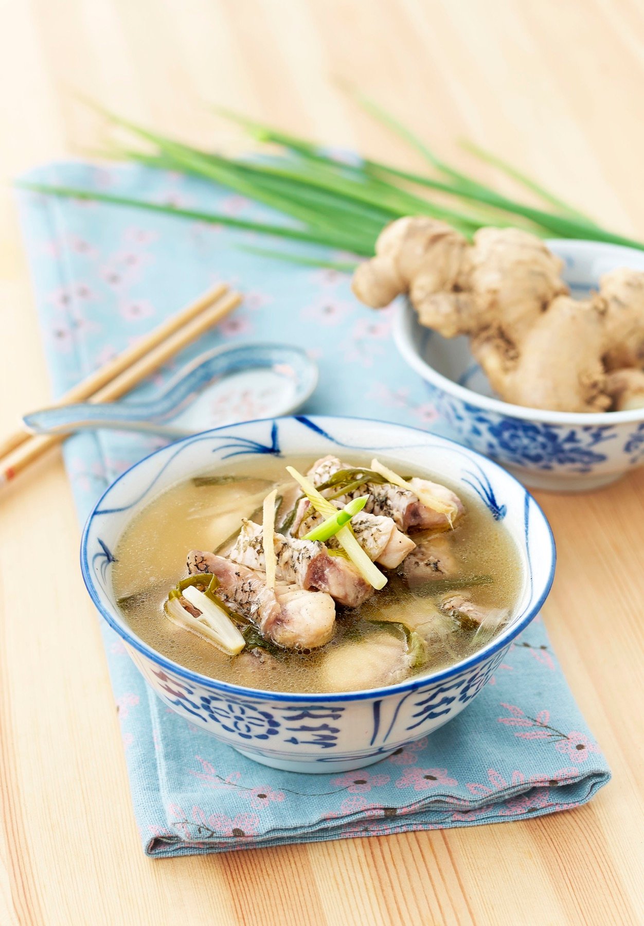 A savoury soup served with fresh herbs