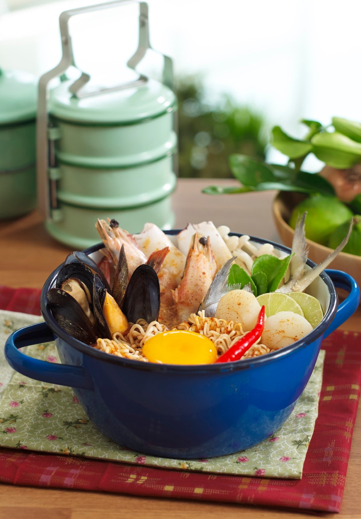 A warm bowl of seafood soup with vegetables