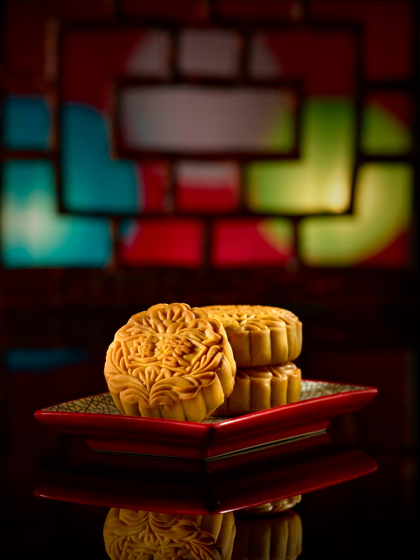 A golden pastry served on a dark plate