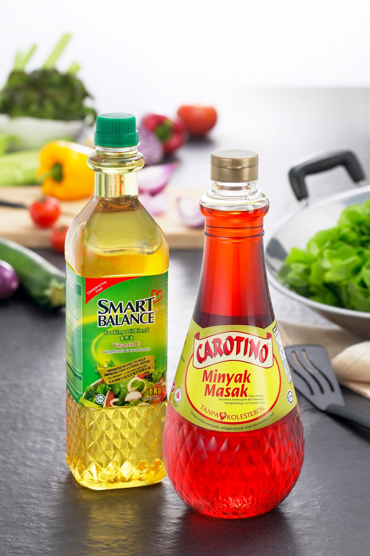 Two cooking oil bottles photographed with ingredients